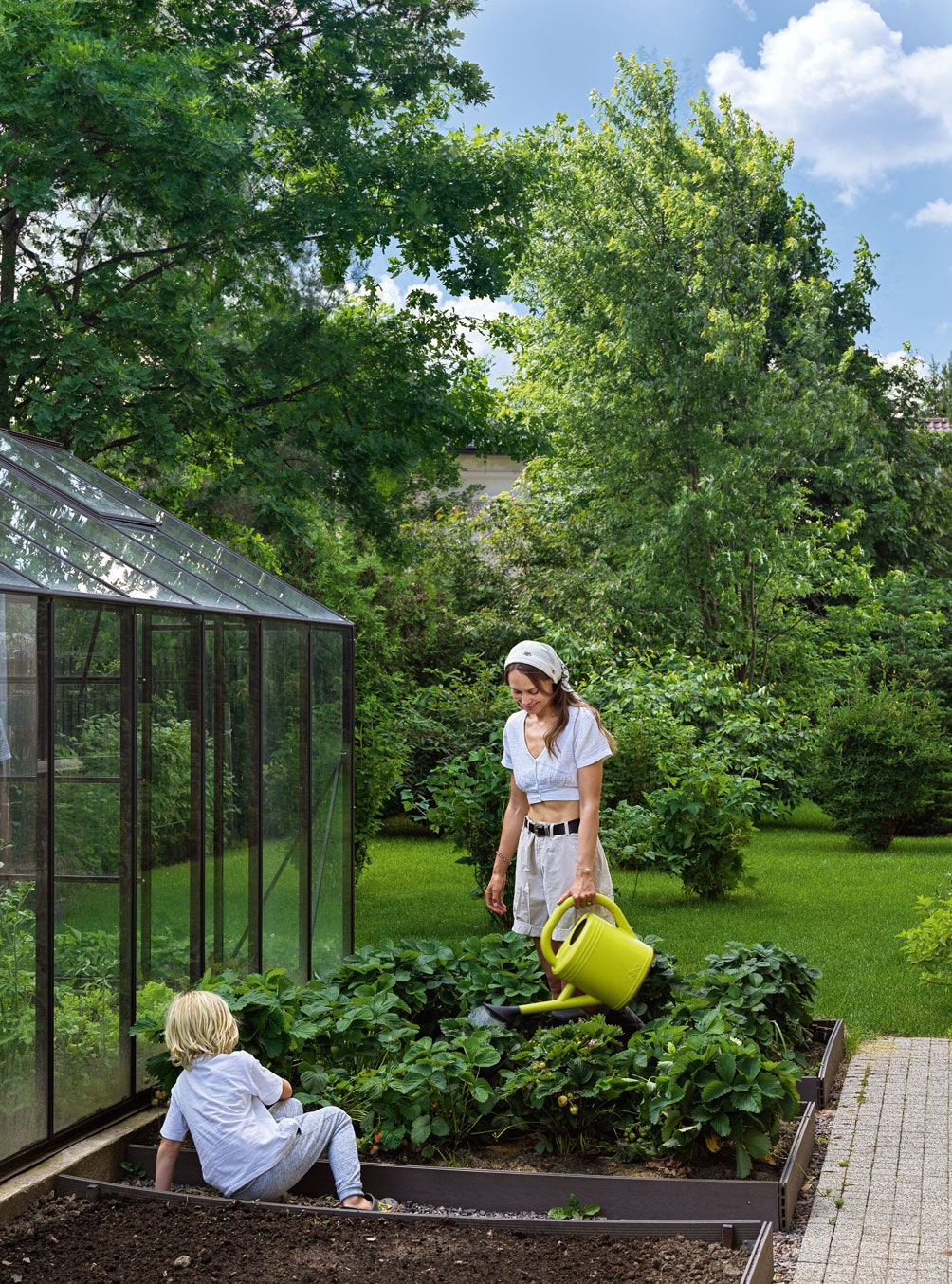 Элен с сыном в огороде который есть рядом с домом. Здесь она выращивает органические ягоды и овощи.