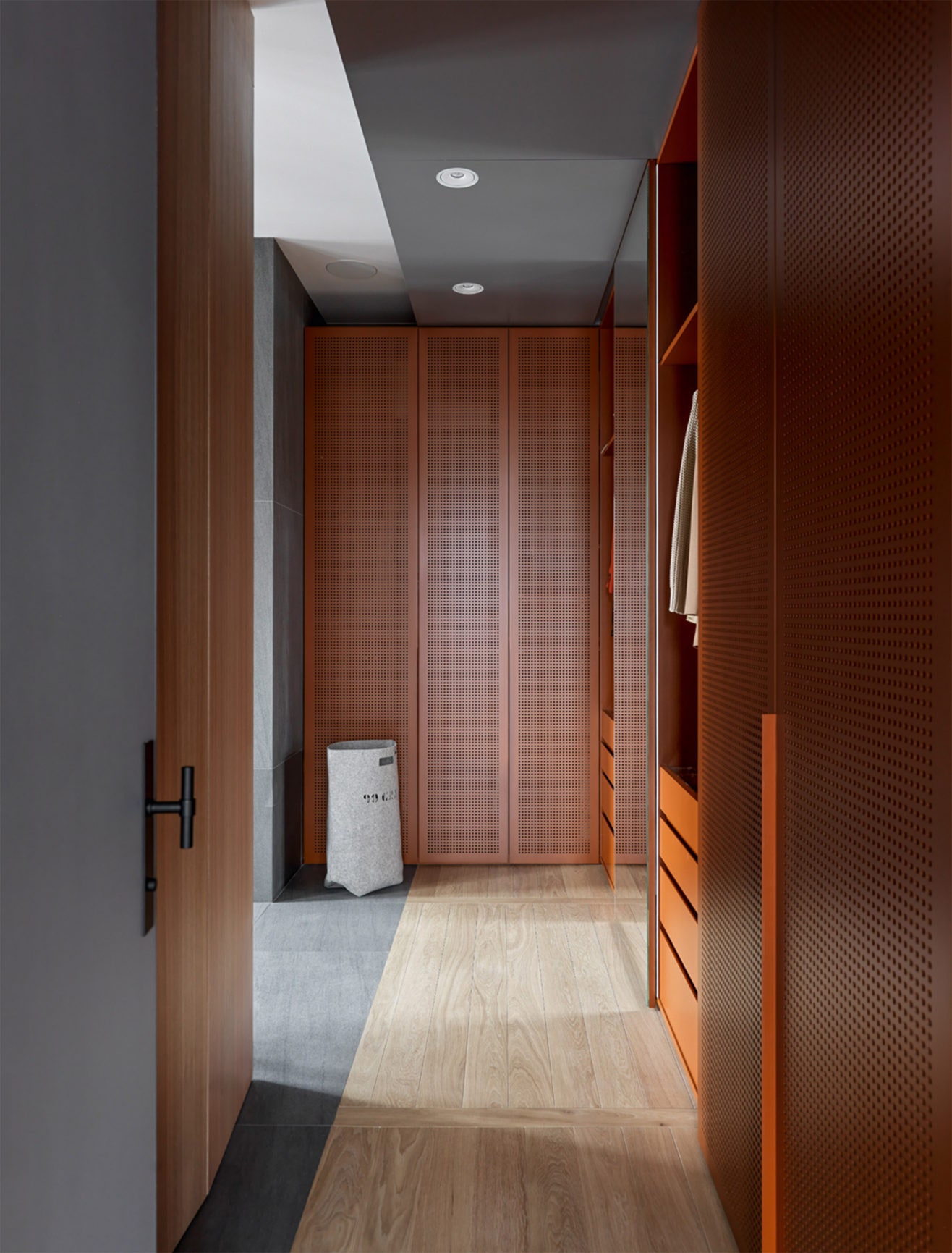 Квартира по проекту NIDO Interiors. Гардеробная при спальне. Полки и перфорированные дверцы сделаны на заказ из МДФ....