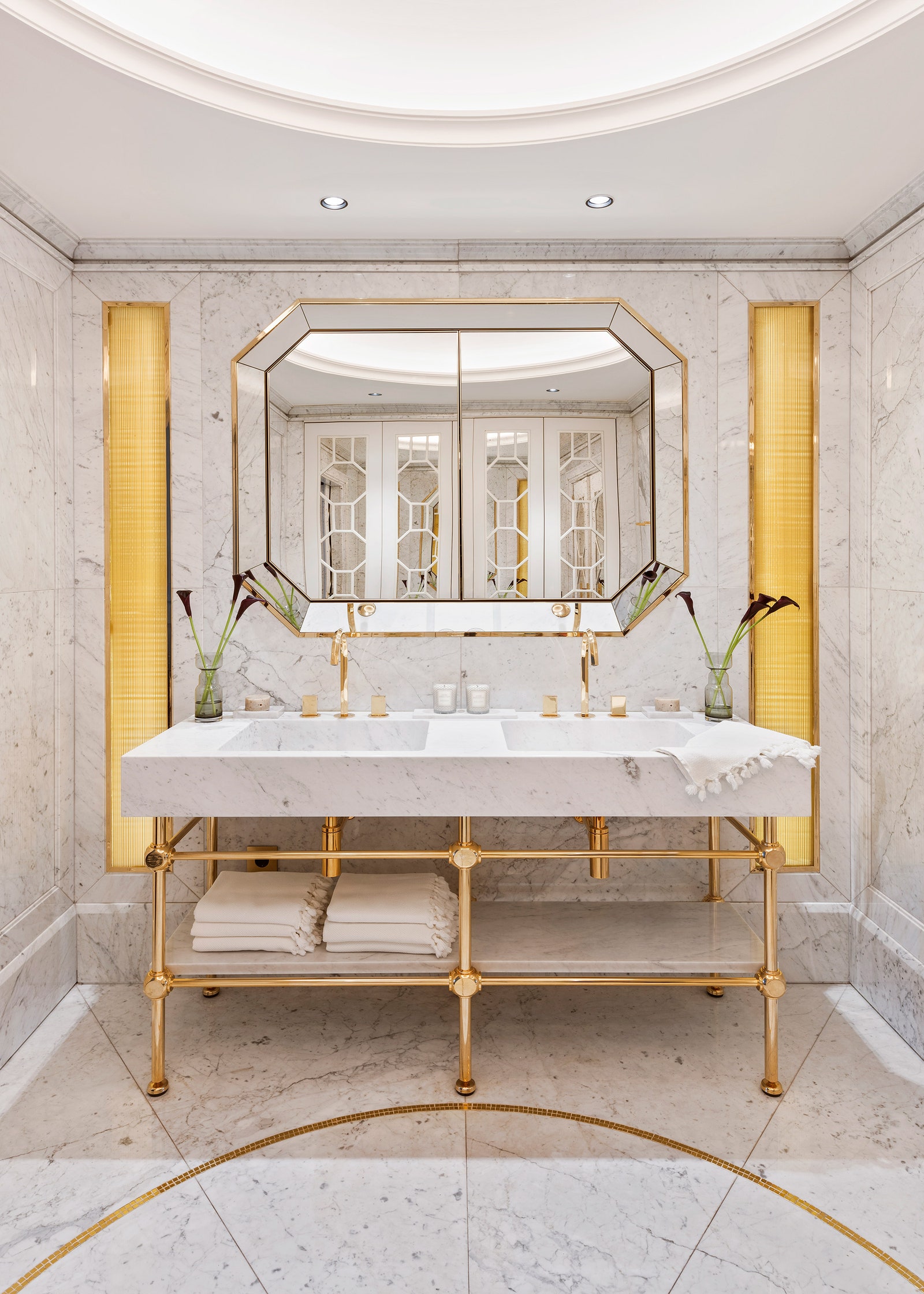 Ванная комната. Раковина из мрамора и позолоченного металла и зеркало сделаны на заказ смесители Fantini Rubinetti.