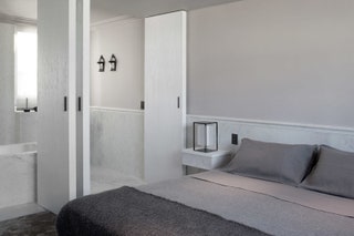 Спальня и ванная спроектированы как единое целое их разделяют только раздвижные двери из брашированного дерева.