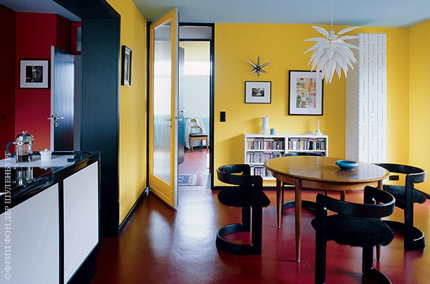 Плинтусы и угловые профили в столовой черные — это “рамы” для цветных стен. Люстра Blossom по дизайну Джереми Коула....