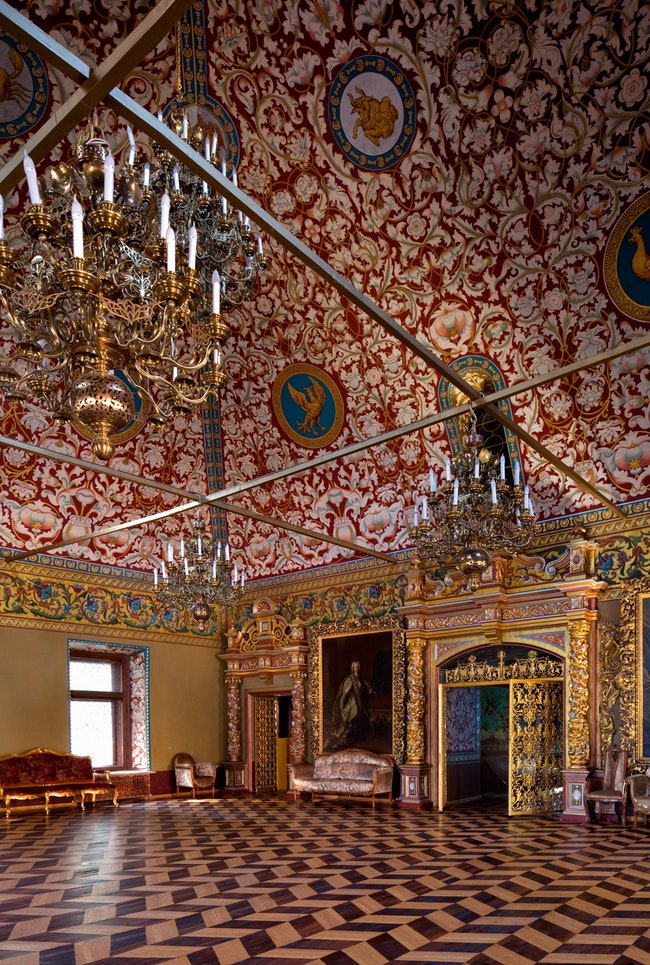 Тронный зал украшен резными дверями зодиакальными росписями и ростовыми портретами двух Петров — Великого и Второго.