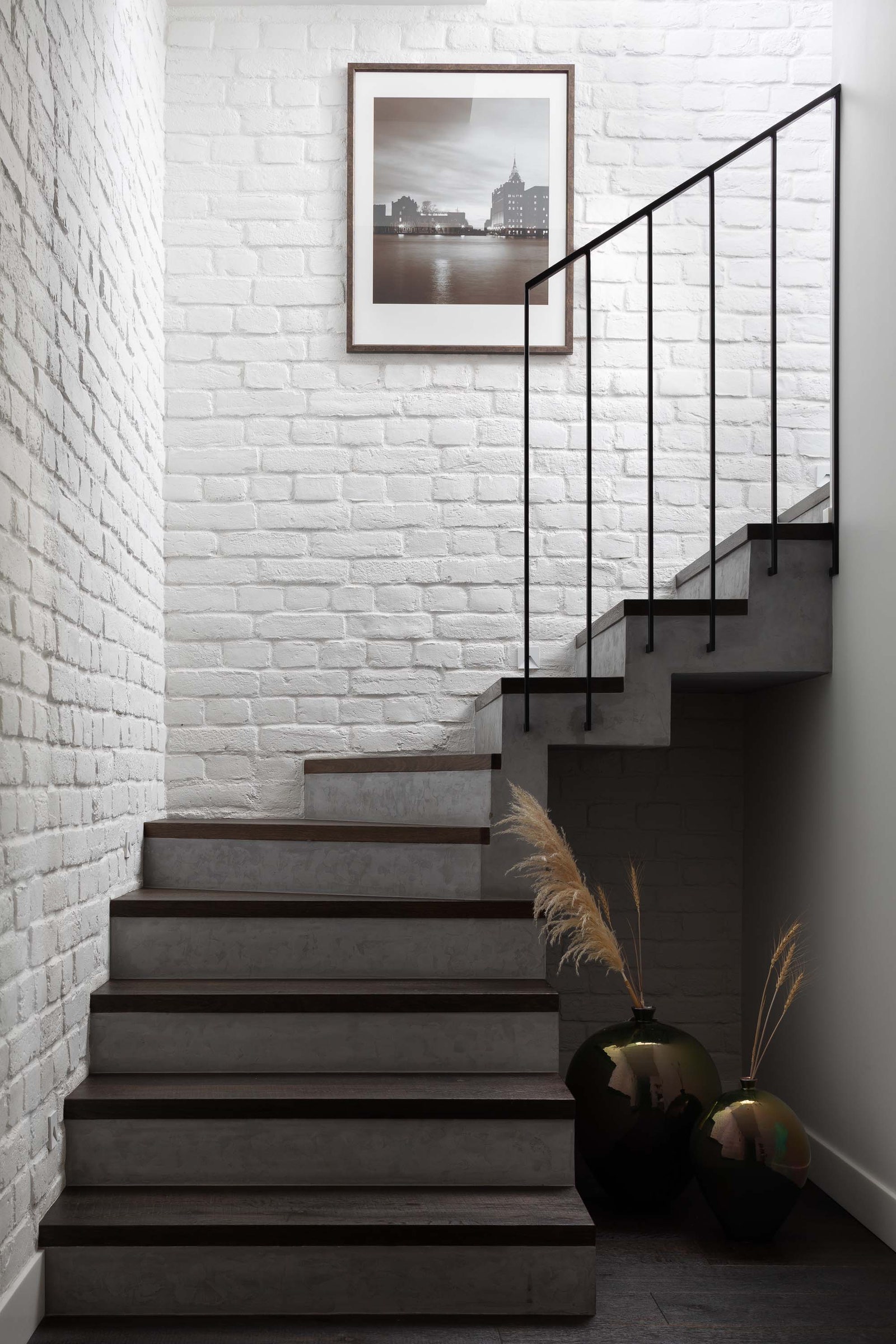 Лестница на второй этаж. Клинкерный кирпич “Петровская мануфактура” декоративная штукатурка под бетон San Marco  на полу...