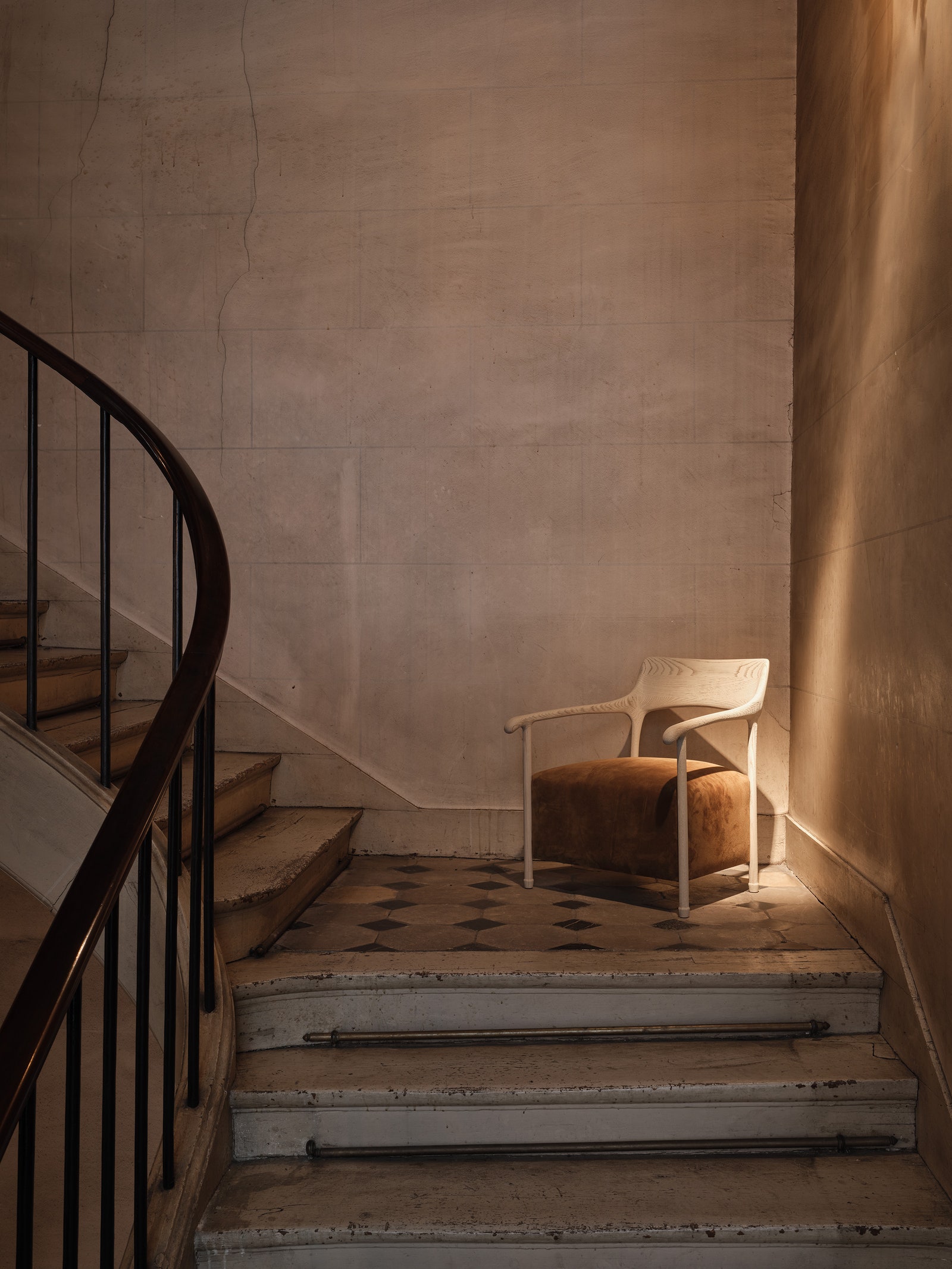sculptural chair sitting at the landing of a staircase
